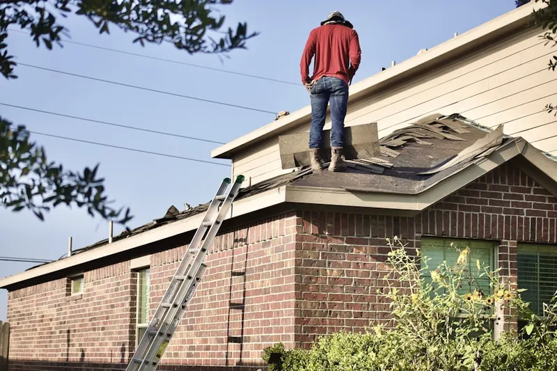 Professional roofer working on a residential roof in Evans Acres